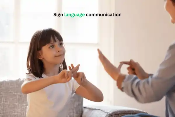 A little girl showing sign language